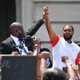 Attorney Benjamin Crump, left, holds up the hand of Kenneth Walker during a rally on the steps of the Kentucky State Capitol in Frankfort, Ky., Thursday, June 25, 2020.